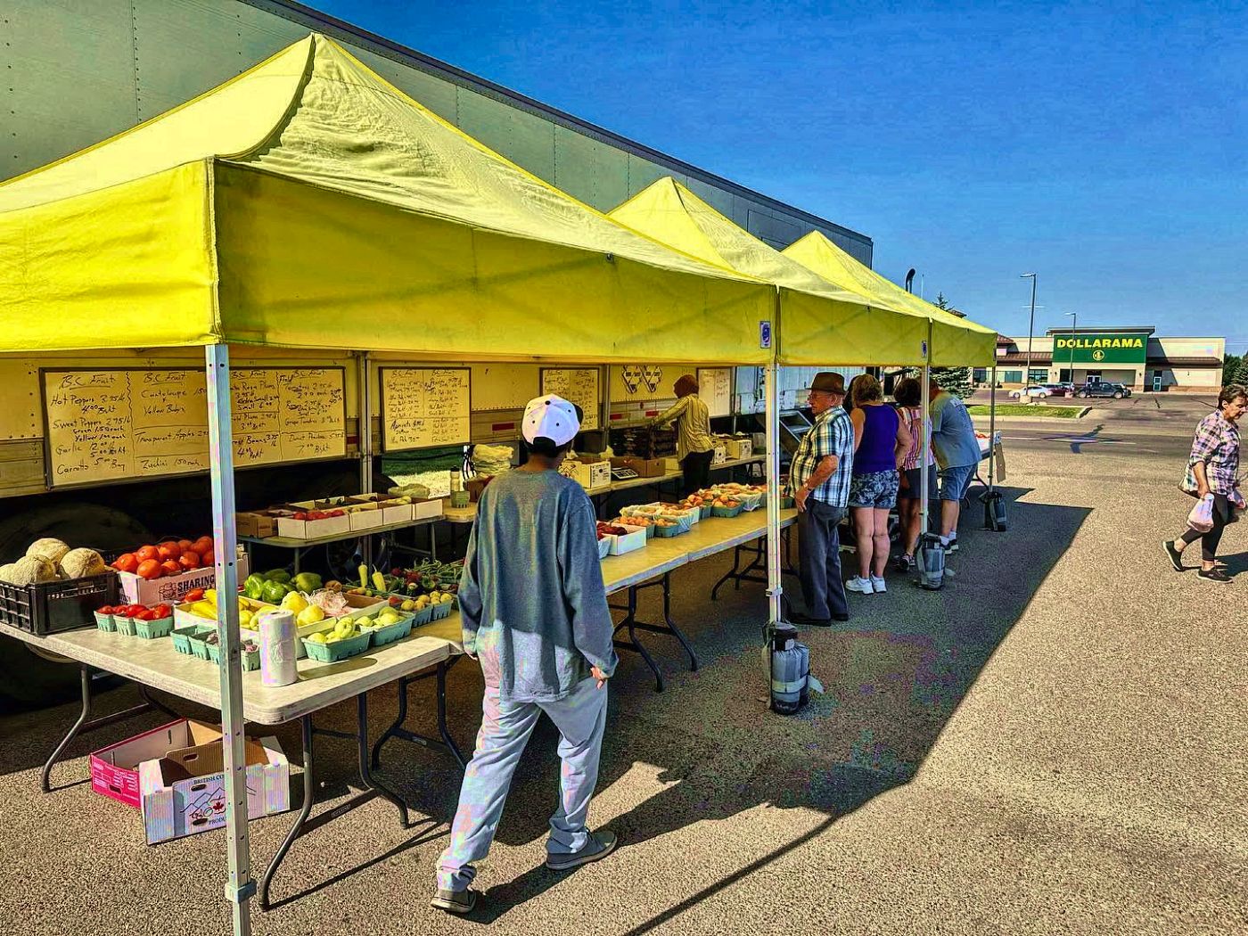 Shoppers under the yellow Deacon's tents